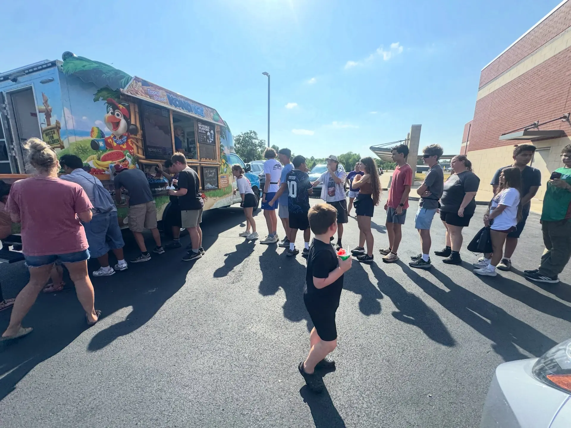 Band students lined up at the Kona Ice truck in the school parking lot