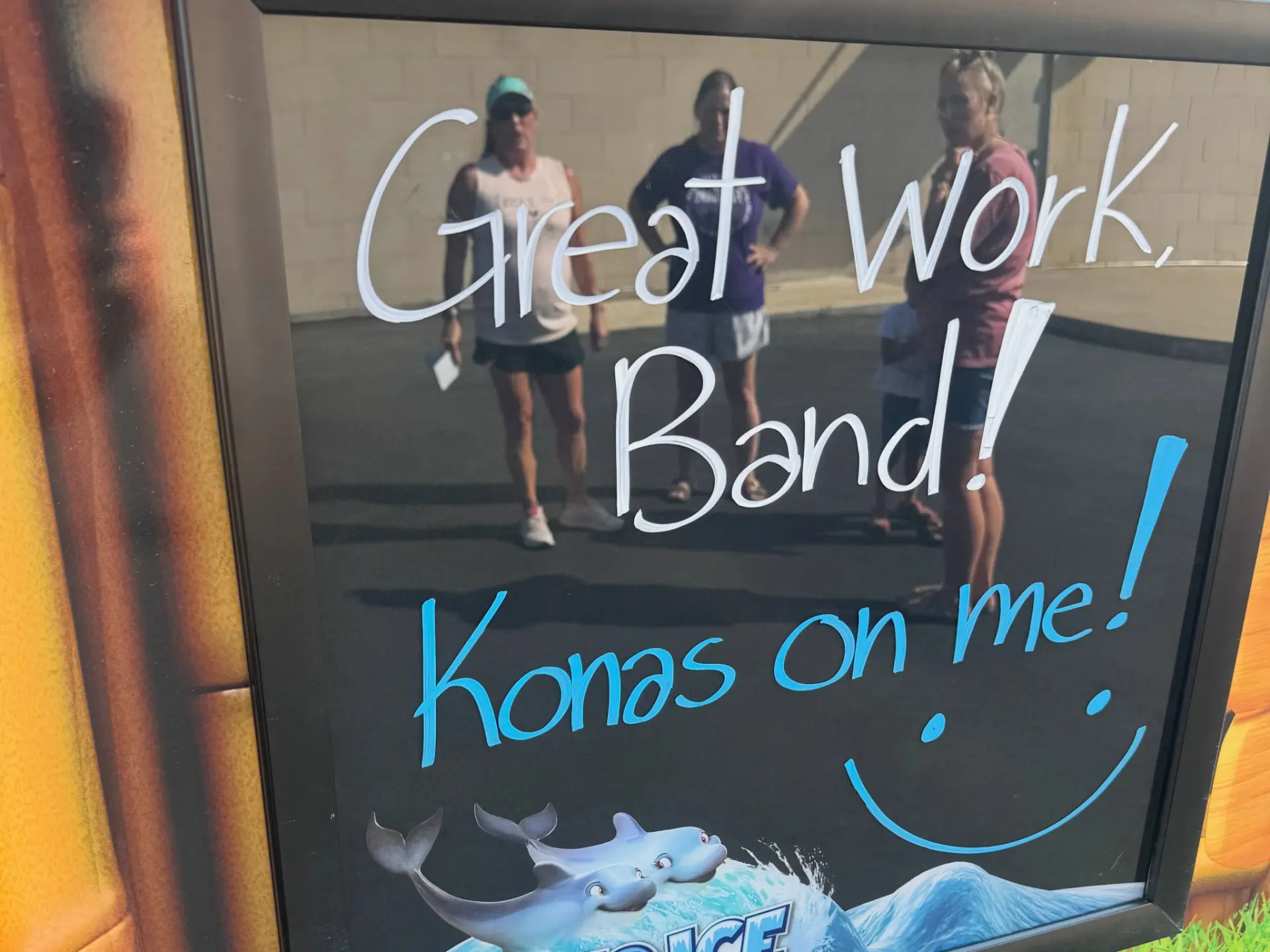 A chalkboard on the Kona Ice truck reading Great Work, Band! Konas on me!